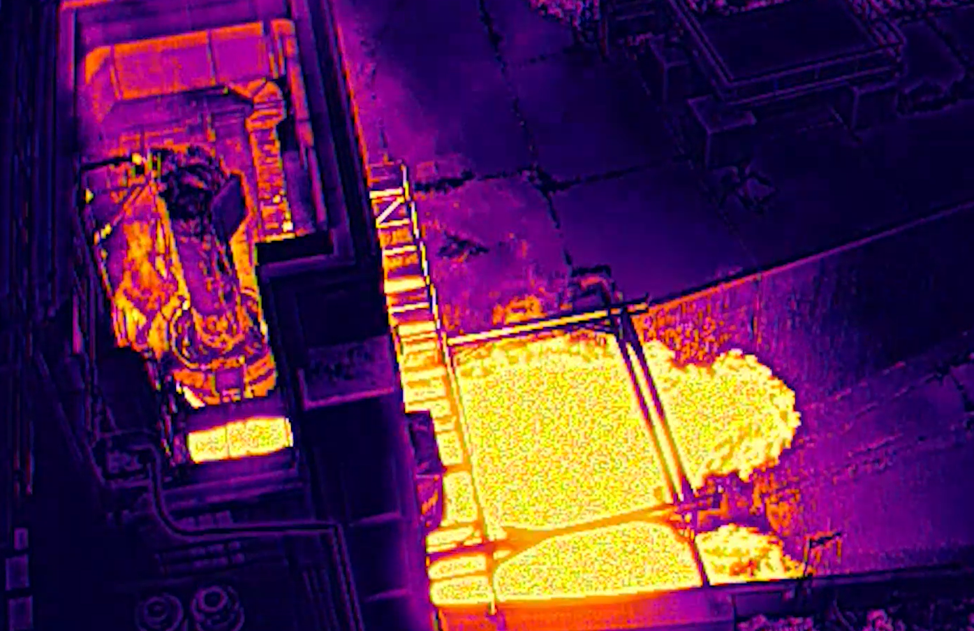 Thermal image of a rocket engine test showing heat distribution during combustion. Bright white and yellow areas indicate extreme temperature zones.
